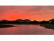 Stunning sunset view over tranquil lake, reflecting the vibrant orange and pink sky at 16087 Sunny Day Dr, Bradenton, FL 34211