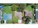 Aerial view of a residential area featuring a home with well-maintained lawn and mature trees at 1707 24Th E St, Palmetto, FL 34221
