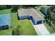 Aerial shot of a well-maintained home with a green lawn, long driveway and mature landscaping at 1707 24Th E St, Palmetto, FL 34221