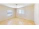 Empty bedroom shows neutral tile floors and natural light from two windows at 1707 24Th E St, Palmetto, FL 34221