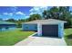 A well-kept single-story home with a gray exterior, a one-car garage, and green lawn at 1707 24Th E St, Palmetto, FL 34221