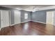 A simple living room with hardwood floors, multiple doorways, and neutral-colored walls at 1707 24Th E St, Palmetto, FL 34221