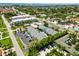 An aerial view shows a multi-unit residential complex with a swimming pool, ample parking, and lush landscaping at 1753 Dawn St # 305, Sarasota, FL 34231