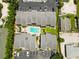 Bird's eye view of townhomes surrounding a community pool with parking and landscaping, close to residential houses at 1753 Dawn St # 305, Sarasota, FL 34231
