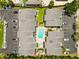 Overhead view of townhomes surrounding a refreshing community pool, parking spaces, and serene green spaces at 1753 Dawn St # 305, Sarasota, FL 34231
