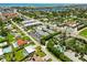 An aerial view showcasing the property's proximity to local amenities, lush green spaces, and waterfront location at 1753 Dawn St # 305, Sarasota, FL 34231