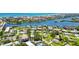An aerial view highlighting the property's setting near waterfronts, community amenities, and lush green landscapes at 1753 Dawn St # 305, Sarasota, FL 34231