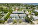 Community view showcasing colorful townhomes with private parking and mature greenery around the property at 1753 Dawn St # 305, Sarasota, FL 34231