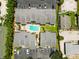 Overhead view of townhomes surrounding a refreshing community pool, parking spaces, and serene green spaces at 1753 Dawn St # 305, Sarasota, FL 34231