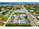 Aerial view of a community with a pool, parking, and landscaping near the intercoastal waterway and residential homes at 1753 Dawn St # 305, Sarasota, FL 34231