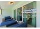 The lanai features comfortable seating and sliding glass doors leading inside to a main bedroom at 1753 Dawn St # 305, Sarasota, FL 34231