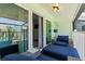 The covered lanai has access to the main bedroom and features comfortable lounge furniture and views at 1753 Dawn St # 305, Sarasota, FL 34231