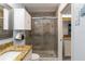 Tiled bathroom featuring modern fixtures, granite counters, and glass shower doors at 1753 Dawn St # 305, Sarasota, FL 34231