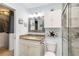 Bright bathroom featuring granite counters, modern fixtures, and a decorative mirror at 1753 Dawn St # 305, Sarasota, FL 34231