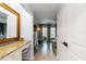 Bedroom hallway with vanity area, leading into spacious bedroom, and light wood flooring at 1753 Dawn St # 305, Sarasota, FL 34231