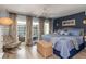 Comfortable bedroom with light wood flooring, ceiling fan, blue accents, and outdoor views at 1753 Dawn St # 305, Sarasota, FL 34231