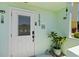 Close-up of a townhouse entrance with a white door and stylish decor accents at 1753 Dawn St # 305, Sarasota, FL 34231