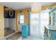 Bright foyer with a retro fridge, stylish decor, and light wood-look floors at 1753 Dawn St # 305, Sarasota, FL 34231