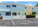 Charming two-story condo with well-maintained landscaping, reserved parking, and pastel-colored exterior at 1753 Dawn St # 305, Sarasota, FL 34231