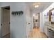 Hallway features vanity area and access to bathroom with coastal inspired decorations at 1753 Dawn St # 305, Sarasota, FL 34231