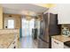 Bright kitchen featuring stainless steel refrigerator and granite countertops and access to outdoor patio at 1753 Dawn St # 305, Sarasota, FL 34231