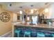 Charming kitchen featuring granite countertops, breakfast bar with seating, and modern lighting fixtures at 1753 Dawn St # 305, Sarasota, FL 34231