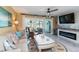 Cozy living room with decorative fireplace, coastal decor, comfortable seating, and sliding glass doors to patio at 1753 Dawn St # 305, Sarasota, FL 34231