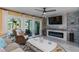 Inviting living room with fireplace, coastal decor, and sliding glass doors to an outdoor patio at 1753 Dawn St # 305, Sarasota, FL 34231