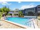 Community pool with patio and lounge chairs, perfect for relaxation and social gatherings in a tropical setting at 1753 Dawn St # 305, Sarasota, FL 34231