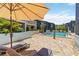 The community pool features an inviting pool, brick deck, and cozy lounge chairs for relaxing at 1753 Dawn St # 305, Sarasota, FL 34231