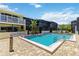 The large community pool features easy access, a brick deck, and manicured landscaping at 1753 Dawn St # 305, Sarasota, FL 34231