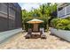 Enjoy poolside relaxation on the brick-paved deck with lounge chairs and a shade umbrella at 1753 Dawn St # 305, Sarasota, FL 34231