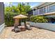 Enjoy poolside relaxation on the brick-paved deck with lounge chairs and shade umbrella at 1753 Dawn St # 305, Sarasota, FL 34231