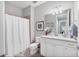 Bathroom with white cabinets, neutral walls, and a shower with a curtain at 17648 Northwood Pl, Lakewood Ranch, FL 34202
