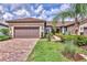 Beautiful home with a paved driveway, lush landscaping, and a two-car garage at 17648 Northwood Pl, Lakewood Ranch, FL 34202