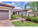 Beautiful home with a paved driveway, well-manicured landscaping, and a two-car garage at 17648 Northwood Pl, Lakewood Ranch, FL 34202