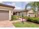 Beautiful single-story home featuring tile roof, two-car garage, and lush landscaping at 17648 Northwood Pl, Lakewood Ranch, FL 34202