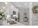 Modern kitchen featuring white cabinets, stainless steel appliances, and a stylish geometric light fixture at 17648 Northwood Pl, Lakewood Ranch, FL 34202