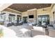 Outdoor lounge with comfortable seating, a stone fireplace and a TV at Del Webb Lakewood Ranch at 17648 Northwood Pl, Lakewood Ranch, FL 34202