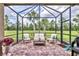 Covered patio with outdoor seating, brick flooring, and views of a green lawn at 17648 Northwood Pl, Lakewood Ranch, FL 34202