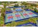 Aerial view of multiple pickleball courts in Del Webb Lakewood Ranch surrounded by landscaping and palm trees at 17648 Northwood Pl, Lakewood Ranch, FL 34202