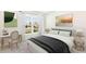 Cozy bedroom featuring a window view, a desk, and a comfortable bed with decorative pillows at 1766 Cobb Trl, Parrish, FL 34219