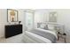 Stylish bedroom featuring modern décor, a large window, and a comfortable queen-sized bed at 1766 Cobb Trl, Parrish, FL 34219