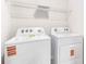 The laundry room offers a washer and dryer with an overhead shelf, making laundry tasks simple at 1766 Cobb Trl, Parrish, FL 34219