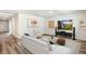 Spacious living room with modern furnishings and decor, including a large screen television at 1766 Cobb Trl, Parrish, FL 34219