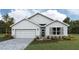 Charming single-story home with a two-car garage, stone accents, and beautifully landscaped front yard at 1770 Cobb Trl, Parrish, FL 34219