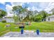 Expansive fenced backyard with lush grass, a shed, landscaping, and mature trees at 1778 N Salford Blvd, North Port, FL 34286