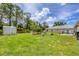 Spacious backyard featuring green grass, storage shed, patio area, and seating area perfect for entertaining at 1778 N Salford Blvd, North Port, FL 34286