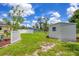 Spacious backyard featuring a storage shed, white fencing, and well-maintained lawn, offering a serene outdoor space at 1778 N Salford Blvd, North Port, FL 34286
