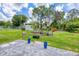 Large, fenced backyard features a patio, lush lawn, shed, and mature trees, perfect for outdoor enjoyment at 1778 N Salford Blvd, North Port, FL 34286